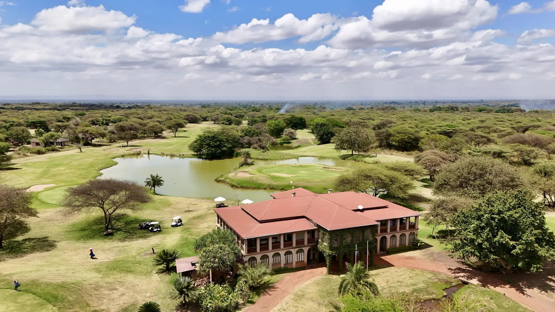KiliGolf clubhouse surrounded by fairways, water and acacia trees